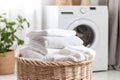Stack of clean bedding sheets on blurred laundry room background Royalty Free Stock Photo
