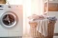 Stack of clean bedding sheets on blurred laundry room background