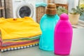 Stack of clean clothes and bottles with detergents Royalty Free Stock Photo