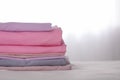 Stack of clean color folded linens on bed. Space for text Royalty Free Stock Photo