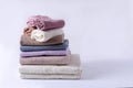 Stack of clean cotton towels of different colors on a light background with copy space and selective focus