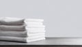 Stack of clean folded white towels on table. Close up view