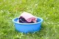 Stack of clean laundry in the blue plastic cup outdoors Royalty Free Stock Photo