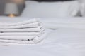 Stack of clean linens on bed indoors, closeup. Space for text Royalty Free Stock Photo