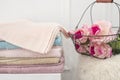 Stack of clean soft colorful towels. Flowers on background