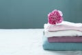 Stack of clean washing pink blue cloth white with carnation flower interior home background Royalty Free Stock Photo