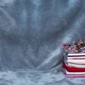 Stack of clean washing red pink blue laundry cloth with purple flower interior home background Royalty Free Stock Photo