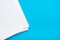 A stack of clean white paper on a table on a blue background. Blank pages ready for printing and writing Royalty Free Stock Photo