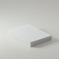 A stack of clean, white, rectangular sheets of paper on a smooth, light gray surface. Royalty Free Stock Photo