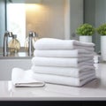 a stack of clean white terry towels in the bathroom
