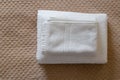 Stack of clean white towels on bed. Cotton soft white towel in hotel Royalty Free Stock Photo