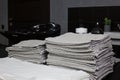 Stack of clean white towels next to a black hairdresser\'s sink in a barbershop