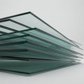 A stack of clear, flat glass panels, each with a greenish tint and uniform thickness, are Royalty Free Stock Photo