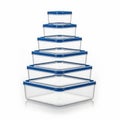Stack of clear food storage containers with blue lids isolated on white background Royalty Free Stock Photo