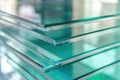 Stack of clear glass sheets with a reflective greenish-blue tint Royalty Free Stock Photo