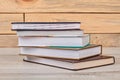 Stack of closed books on wooden background. Royalty Free Stock Photo