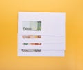 Stack of closed white envelopes with euro bills inside on yellow background. Concept of income  bonuses or bribes. Corruption in Royalty Free Stock Photo