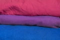 A stack of clothes folded in the colors of the bisexual community flag.