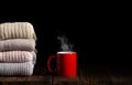 Stack of clothes from knitted knitwear with cup of tea, coffee Royalty Free Stock Photo