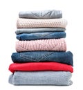 Stack of clothes sweaters and jeans on a white background. Isolated Royalty Free Stock Photo