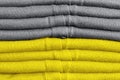 Stack of clothes trend colors 2021 illuminating yellow and gray.