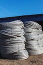 Stack of coiled plastic pvc Polyethylene Corrugated drainage pipes for sewer system outdoor warehouse