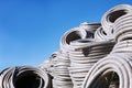 Stack of coiled plastic pvc Polyethylene Corrugated drainage pipes for sewer system outdoor warehouse Royalty Free Stock Photo