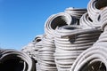 Stack of coiled plastic pvc Polyethylene Corrugated drainage pipes for sewer system outdoor warehouse Royalty Free Stock Photo