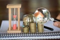 Stack coin and bar graph with grow, Hand hold a magnifying glass searching for a new home, Loan for real estate or save money for Royalty Free Stock Photo