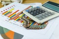 The stack of coin with business paper graphs and pencil with charts report, calculator, concept of calculating expenses Royalty Free Stock Photo