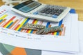 the stack of coin with business paper graphs and pencil with charts report, calculator, selective focus stack of coin Royalty Free Stock Photo