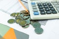 The stack of coin with business paper graphs and pencil with charts report, calculator, selective focus stack of coin Royalty Free Stock Photo