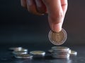 Stack coin,Closeup Finger Woman holding Money with blur Pile Cash