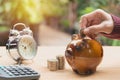 Stack coin with hand drop the coin into piggy bank. Financial Royalty Free Stock Photo