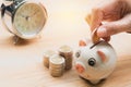 Stack coin with hand drop the coin into piggy bank. Financial Royalty Free Stock Photo