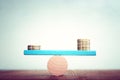 Stack of coins balance on seesaw Royalty Free Stock Photo