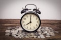 Stack of coins with black alarm clock Royalty Free Stock Photo