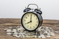 Stack of coins with black alarm clock Royalty Free Stock Photo