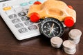 Stack of coins with calculator and wooden car on wood table Royalty Free Stock Photo