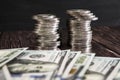 Stack of coins and dollars .Business concept. The concept of cash savings. Dramatic image. Dark background.