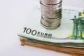 Stack of coins on a stack of euro banknotes. Close-up. Royalty Free Stock Photo