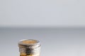 Stack of coins. 2 euro coin on top on a gray background with free space for text, copy space Royalty Free Stock Photo