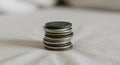 A stack of coins featuring various colors, including green, copper, and silver, placed on Royalty Free Stock Photo