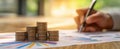 The stack of coins beside graphs and analytics on a wooden workspace..AI generated image Royalty Free Stock Photo