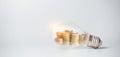 Stack of coins inside a light bulb for saving money concept Royalty Free Stock Photo