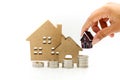 Stack of coins with mini house,Business finance, saving and home
