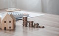 Stack of coins money with wood house model on table, Business Growth concept, Financial risk. for plan saving finance and banking