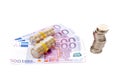 Stack of coins over a euro bills Royalty Free Stock Photo