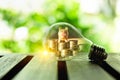 Stack of coins and piggy bank inside a lightbulb for saving money concept, Creative ideas of business planning, success in the Royalty Free Stock Photo