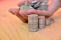 Stack coins put on hand for save money and financial, tax season Royalty Free Stock Photo